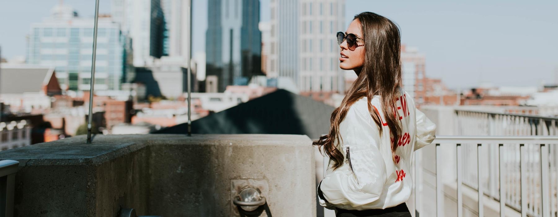 a person standing on a balcony overlooking a city